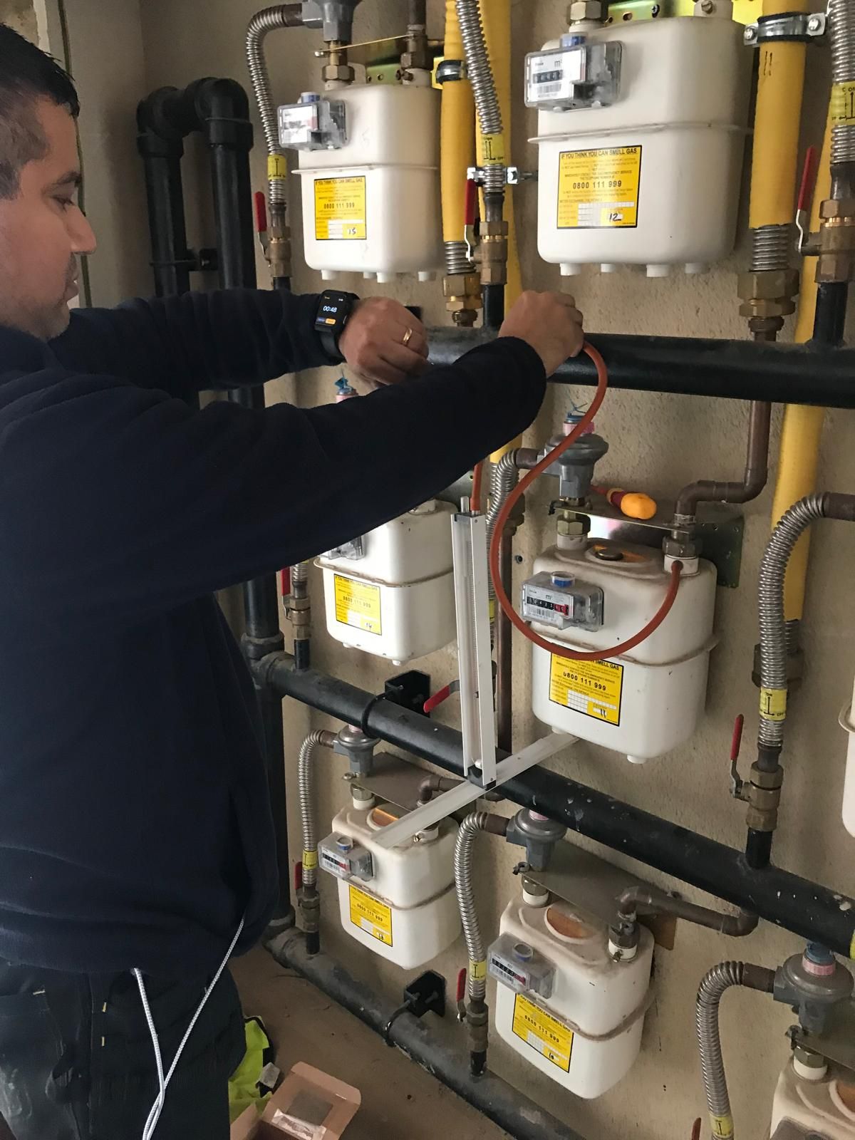 Working on a commercial gas meter bank